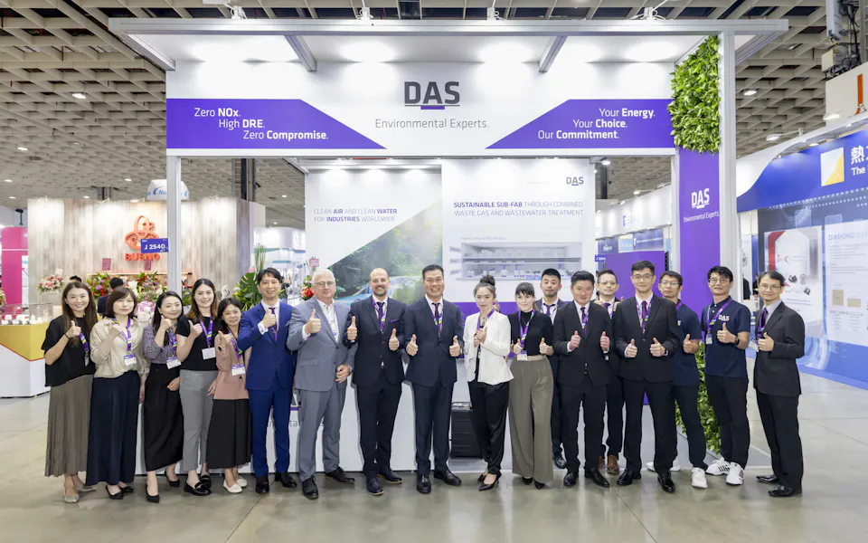 Impressions SEMICON Taiwan A group of people stand in front of a trade show booth labeled "DAS Environmental Experts," all giving thumbs up, with banners promoting environmental solutions in the background.