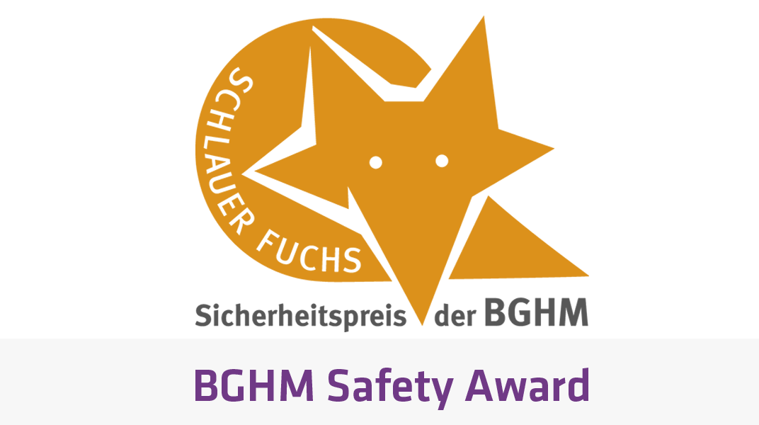 BGHM Safety Award 로고 이미지에는 주황색 여우 모양과 "SCHLAUER FUCHS" 및 "Sicherheits­preis der BGHM"이라는 텍스트가 포함되어 있습니다.