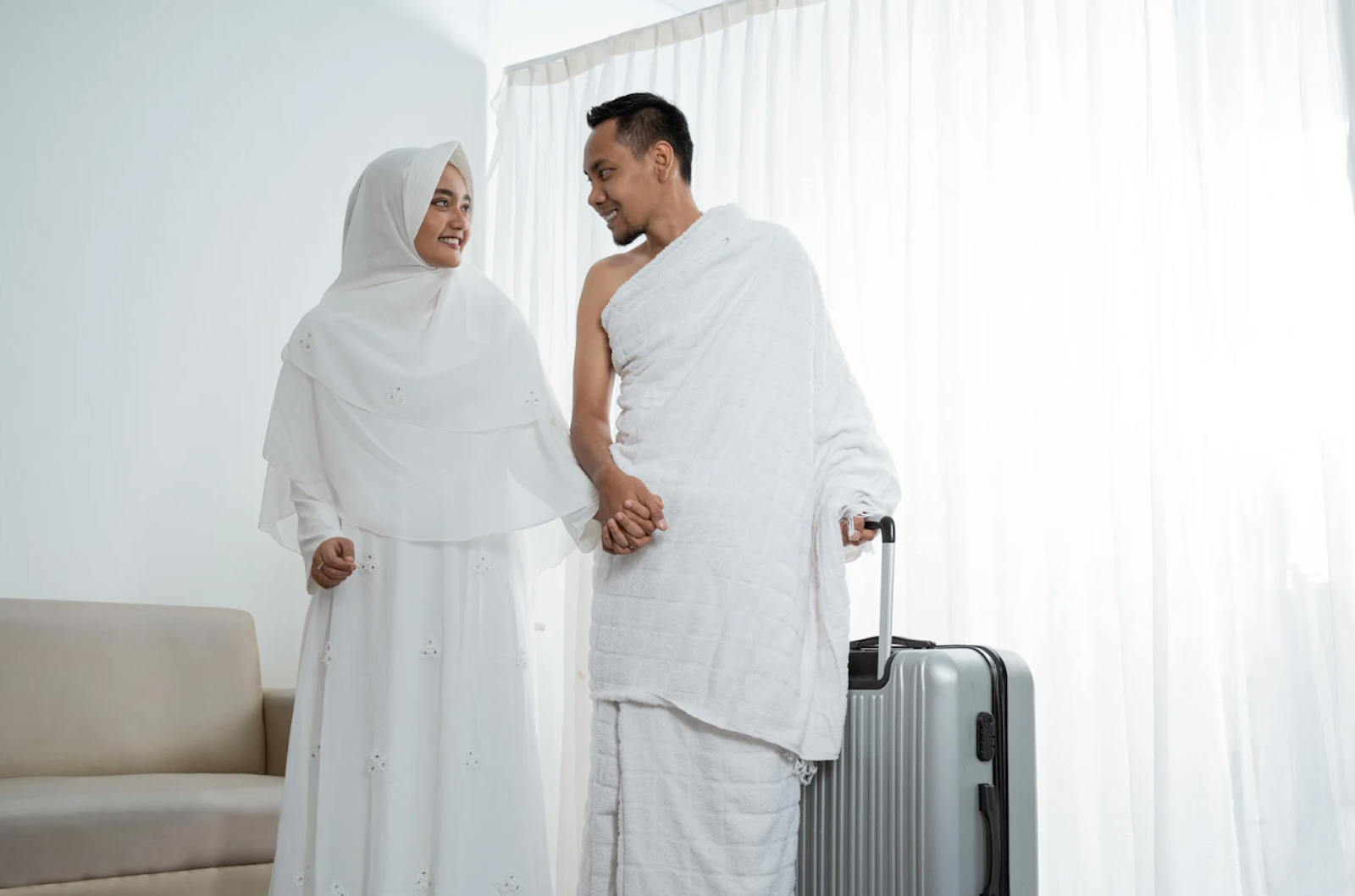 Woman and man dressed in Ihram clothing