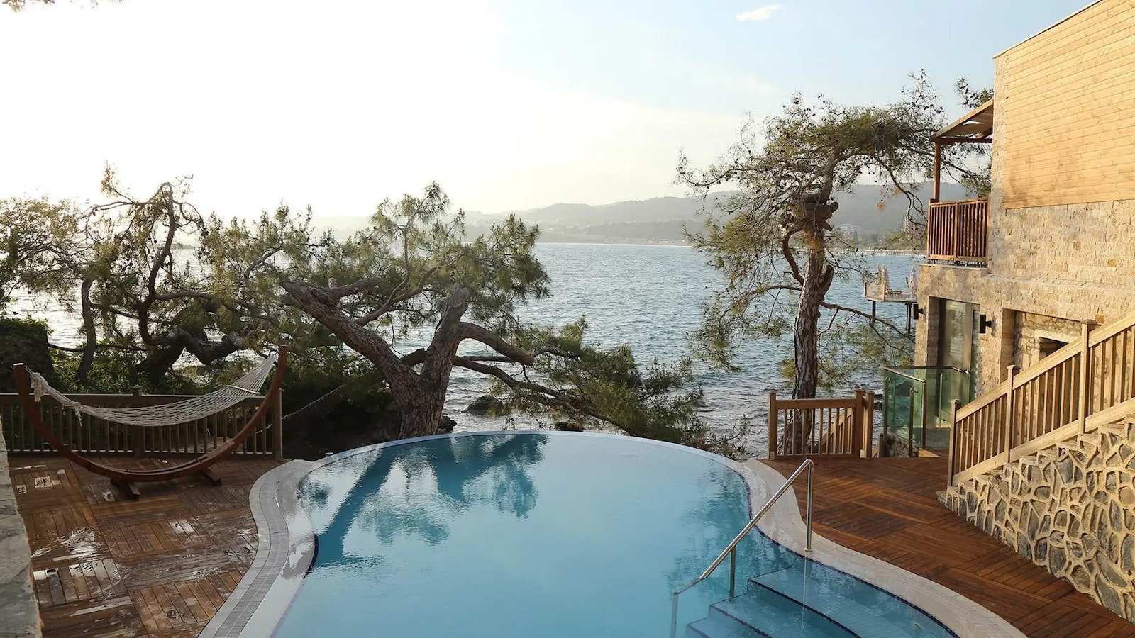 Villa options include a private pool and terrace overlooking the sea, framed by İncekum's pine forest.