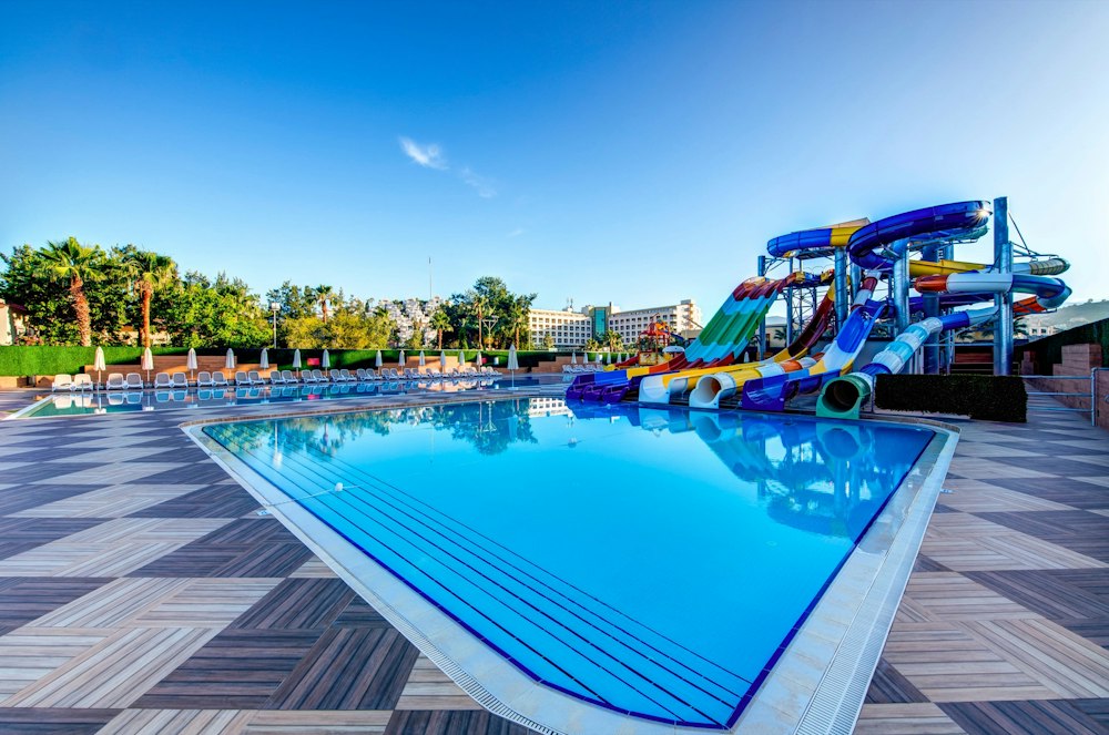 Pool with a multicoloured water slide tower at Bera Alanya Resort