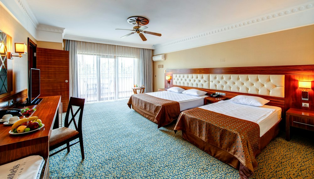 Bedroom with two double beds in a Connection Room at Bera Alanya Resort