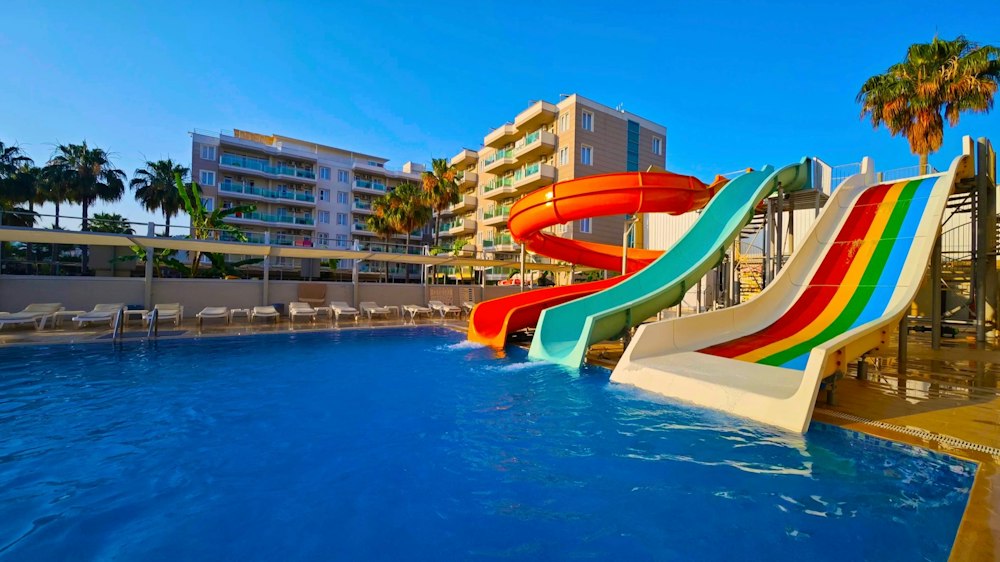 Colourful water slides running into the pool at Grand Akça Resort