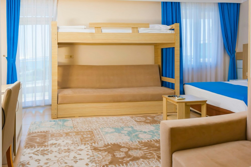 Pool or Sea View Room with bunk beds and a sofa at Grand Akça Resort