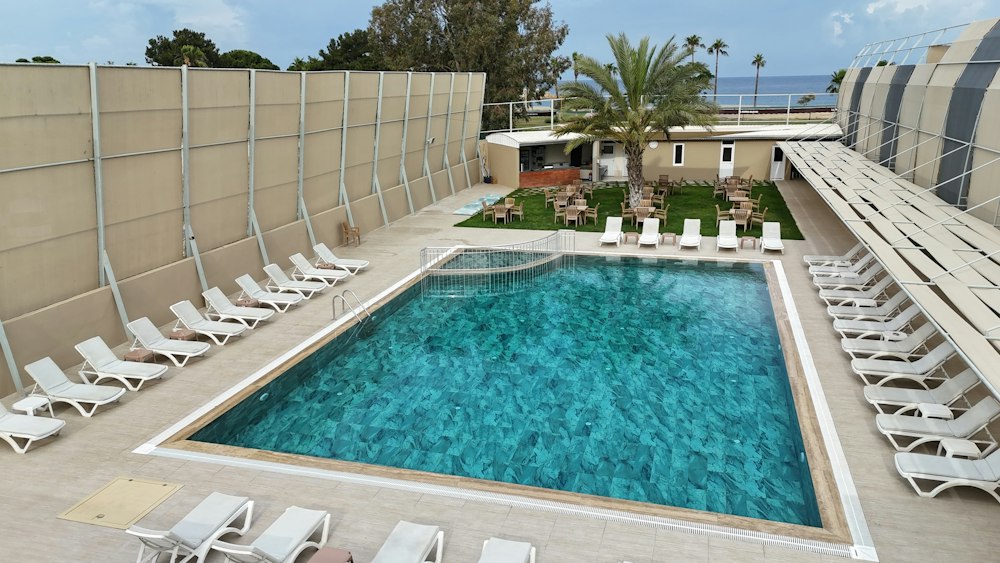 Outdoor pool behind tall privacy screens at Grand Akça Resort