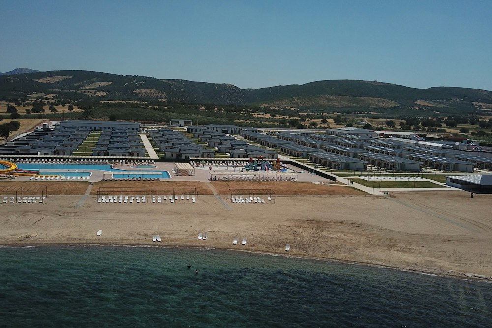 Aerial view of the sandy beach, pools and villas at Rizom Village Assos in Ezine, Çanakkale