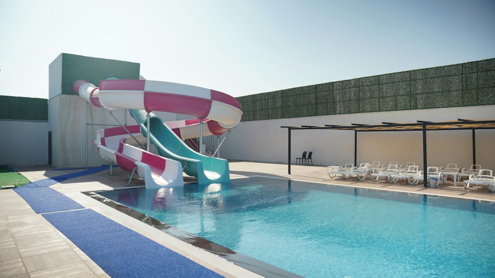 Pool with two large water slides at Rizom Village Assos