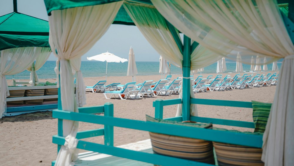 Beach cabana with curtains looking out over sun loungers and the sea at Rizom Beach Hotel Kumluca