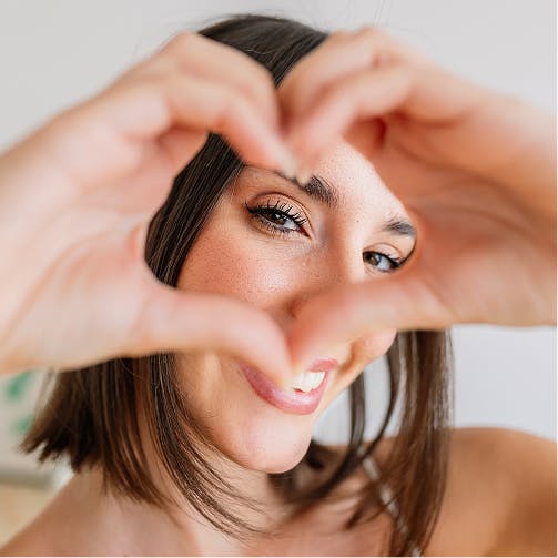 woman making a heart with her hands