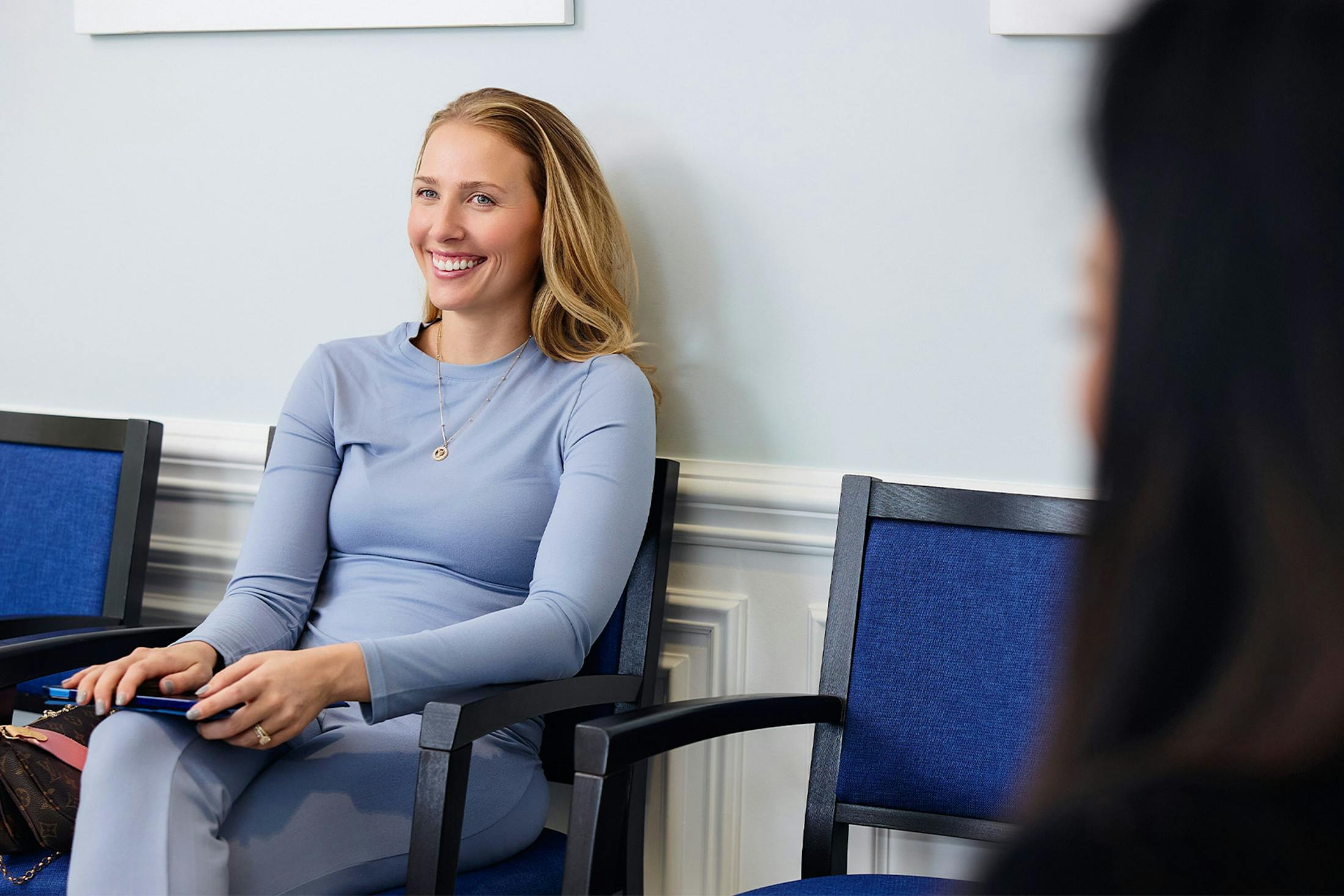 woman in waiting room smiling
