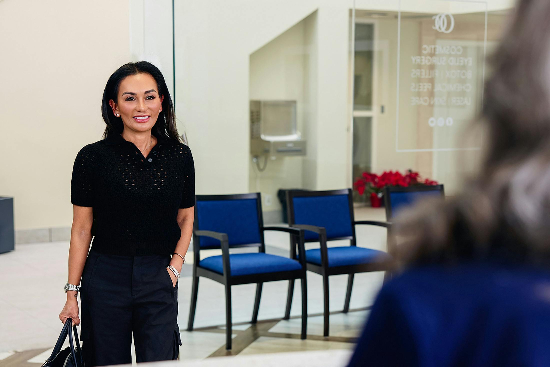 female patient walking towards receptionist desk