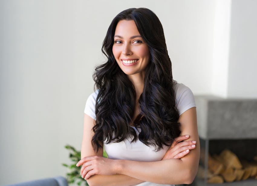 woman smiling and crossing her arms