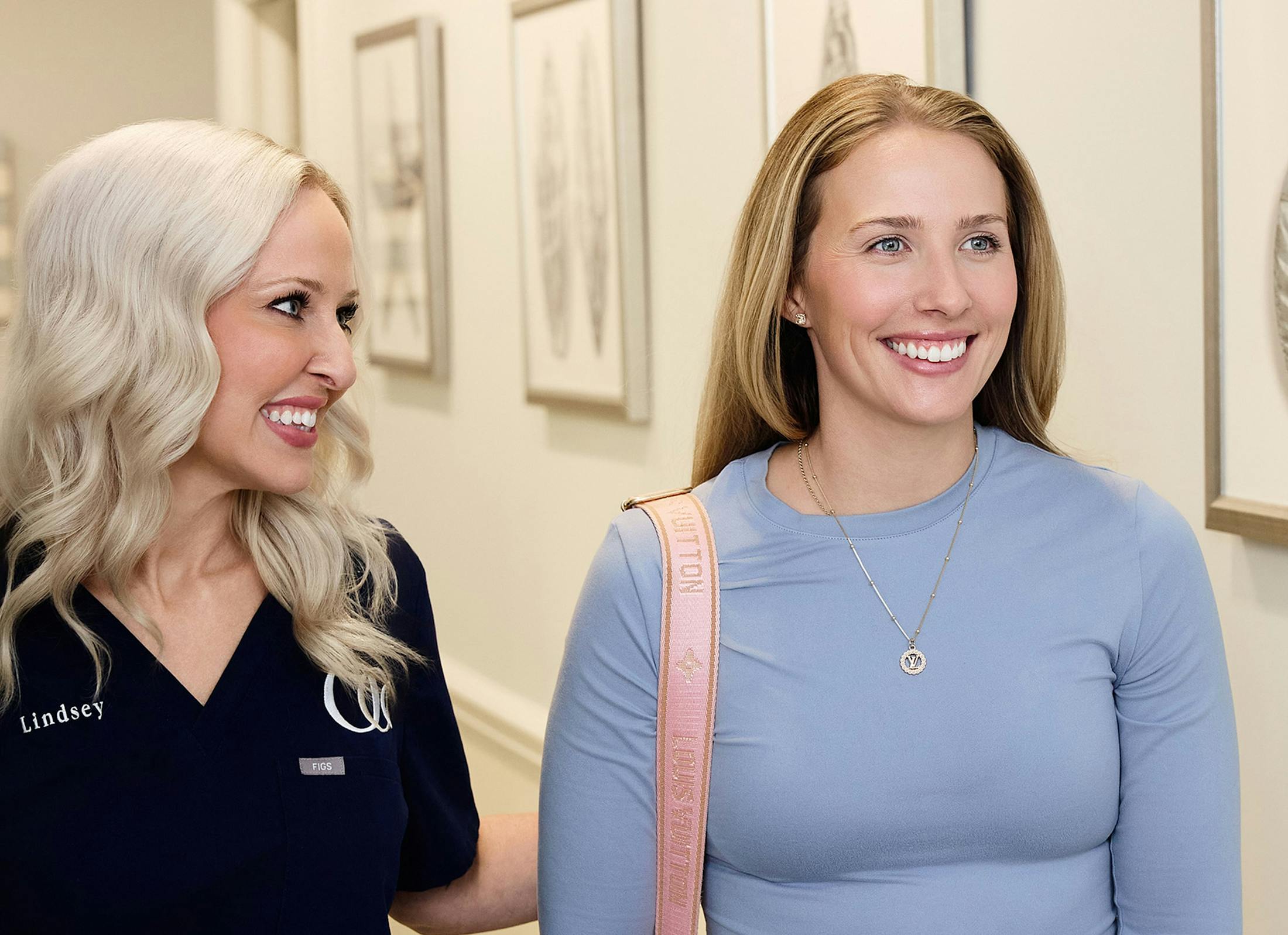 female patient walking with staff member