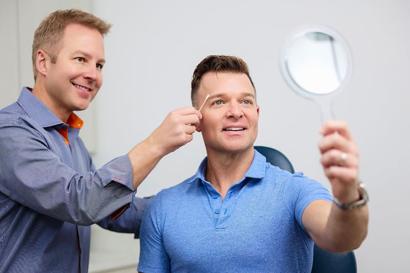 Dr. Connor with male patient checking his eyelids