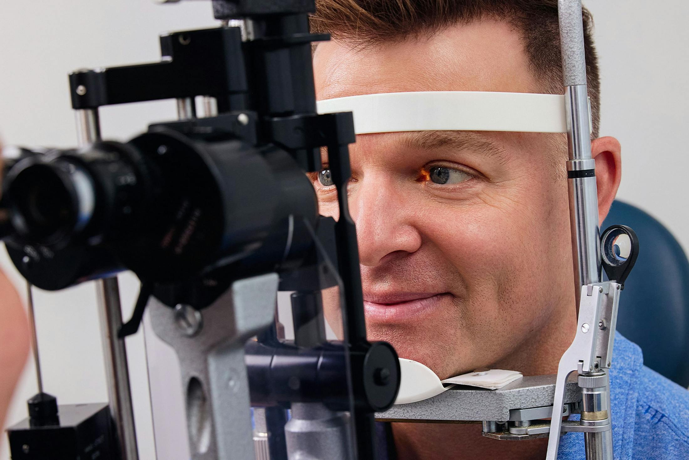 male patient getting his eyes checked in machine