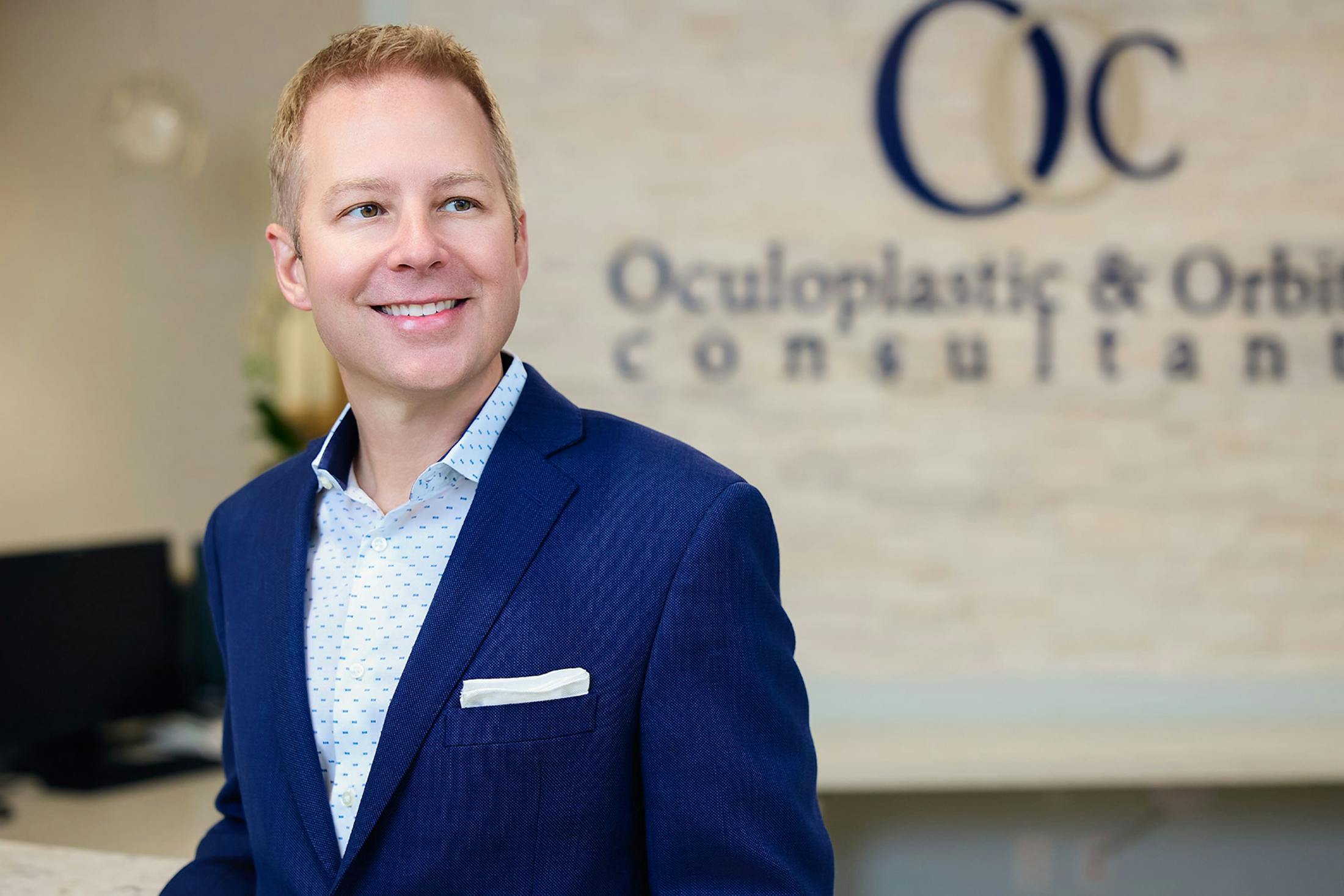 Dr. Connor smiling and wearing blue suit