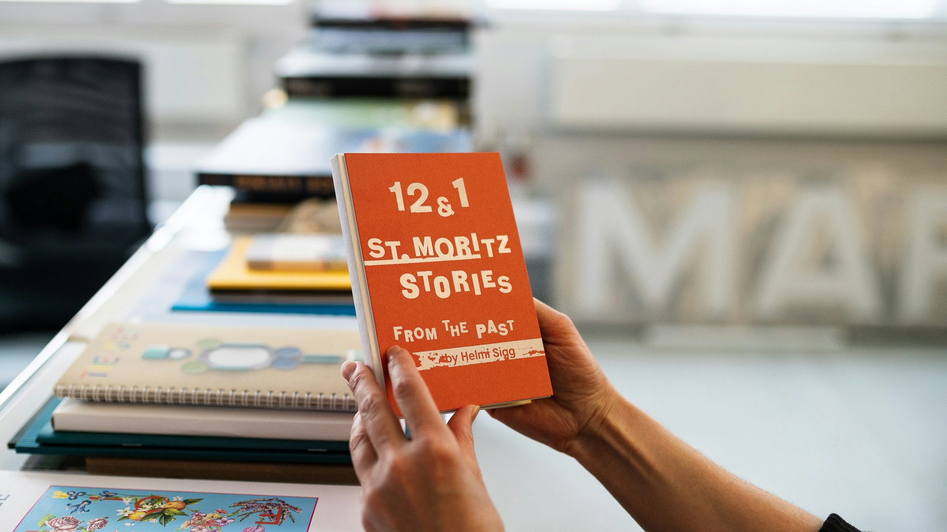 Booklet St. Moritz Stories Hands holding the Booklet