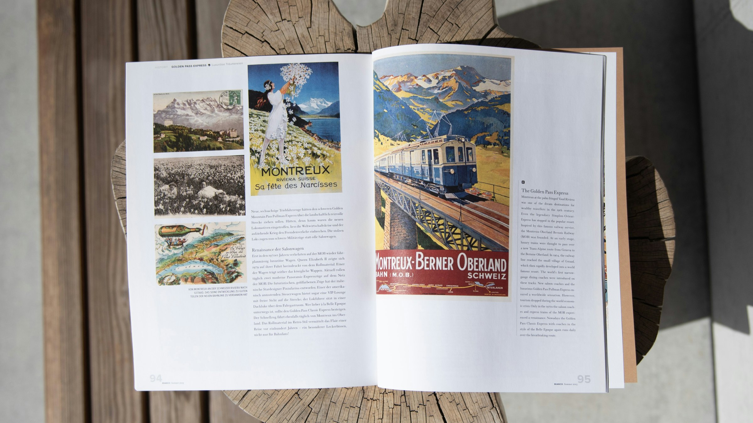 Aufgeschlagenes Magazin mit historischen Bahnpostern und Reiseimpressionen der Montreux–Berner Oberland Bahn.