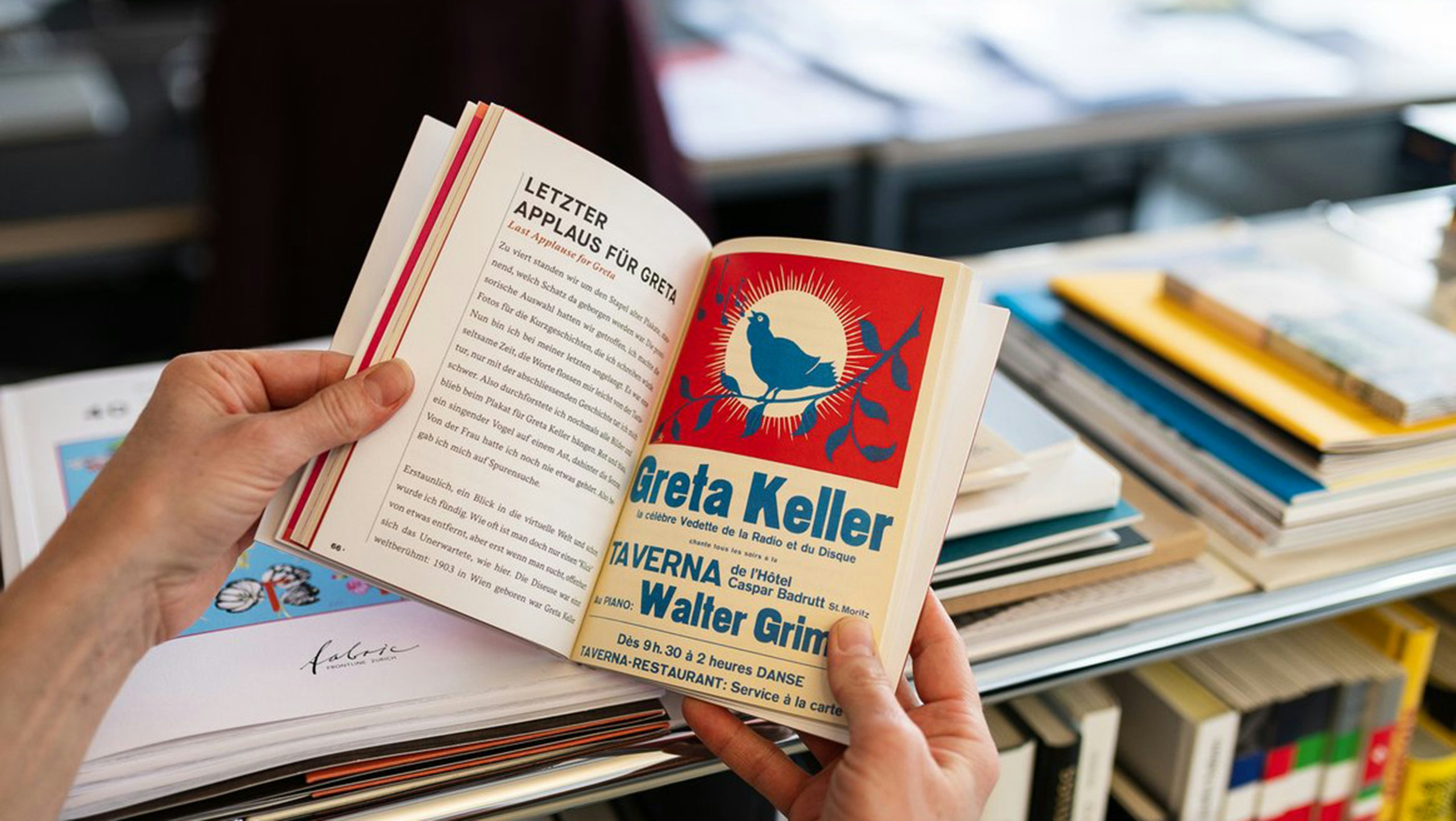 Open book with chapter “Last Applause for Greta” and vintage poster.