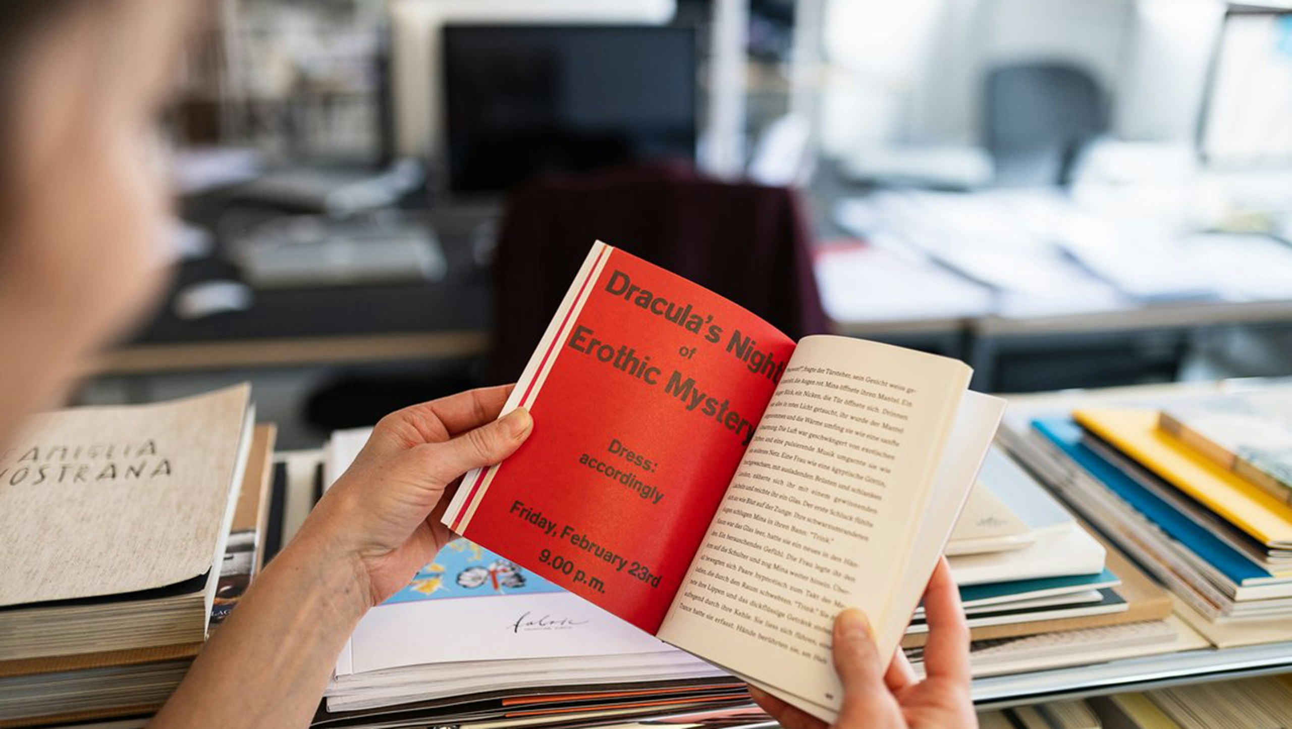 Open book with red page “Dracula’s Night of Erotic Mystery”.