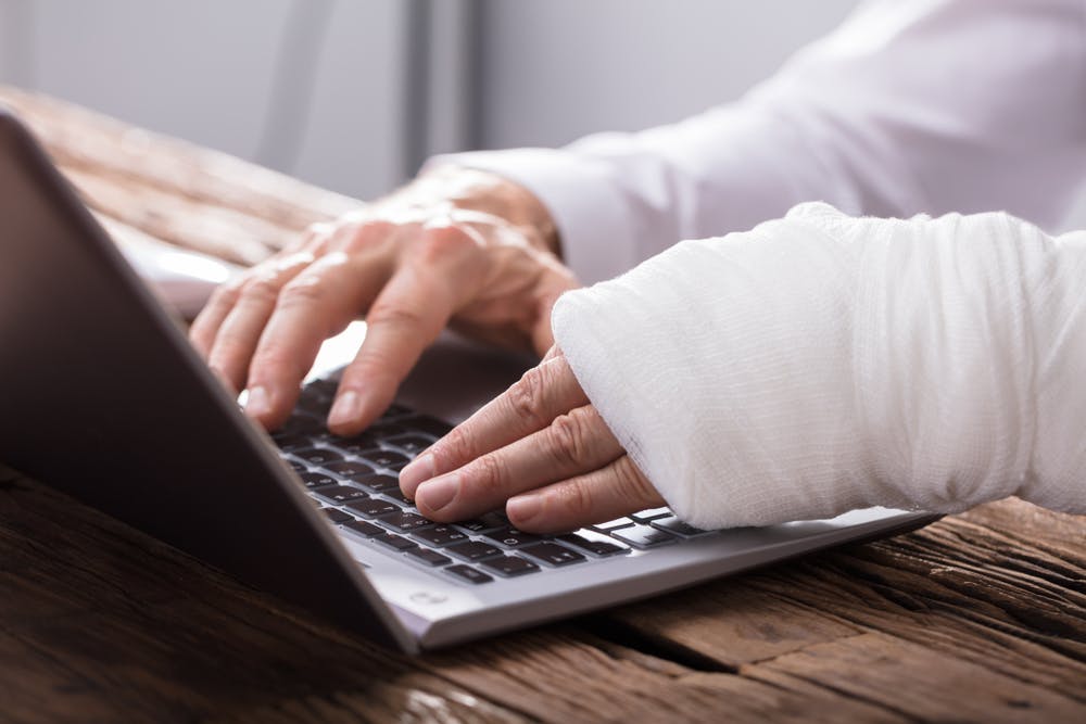 Online Application Hand Injured Person Using Laptop