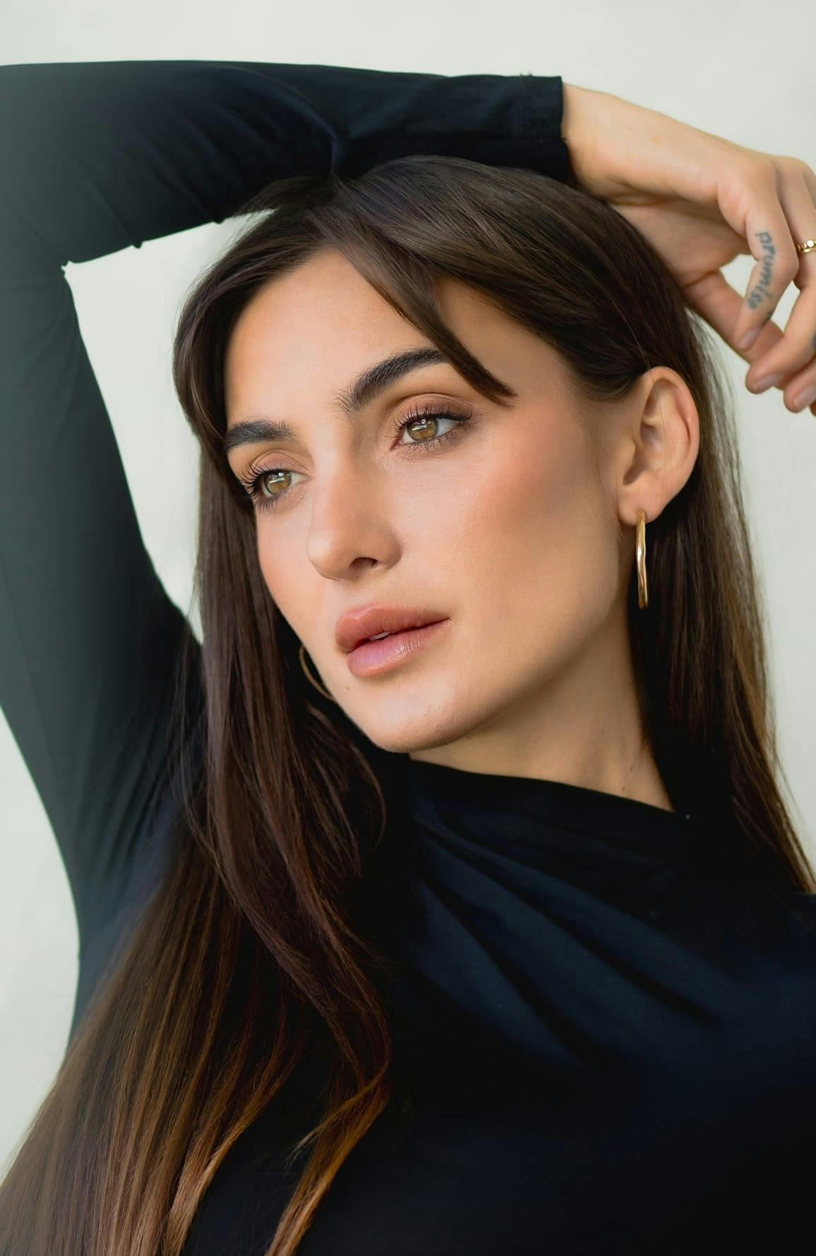 woman with long hair wearing a long sleeve black top