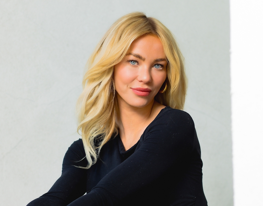 woman with blonde hair wearing a longsleeve black shirt