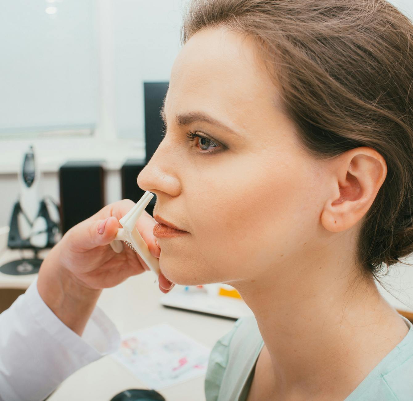 Doctor looking at a patient's nose
