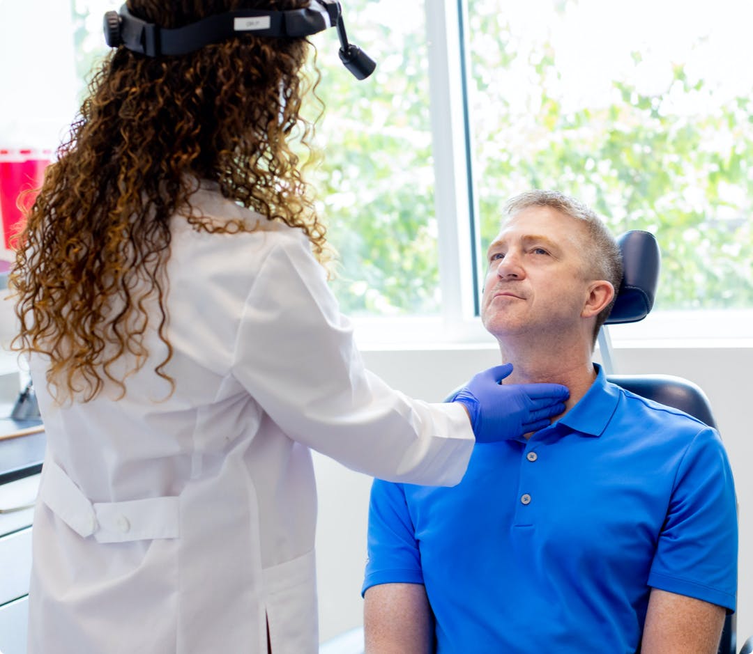 Female doctor examining male patient