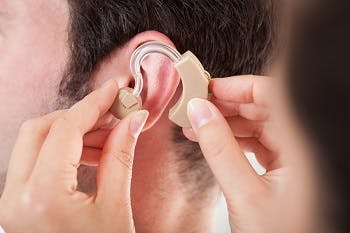 man getting hearing aid