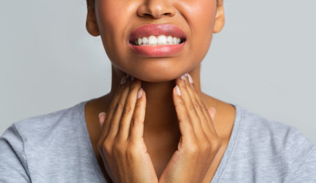 woman holding neck