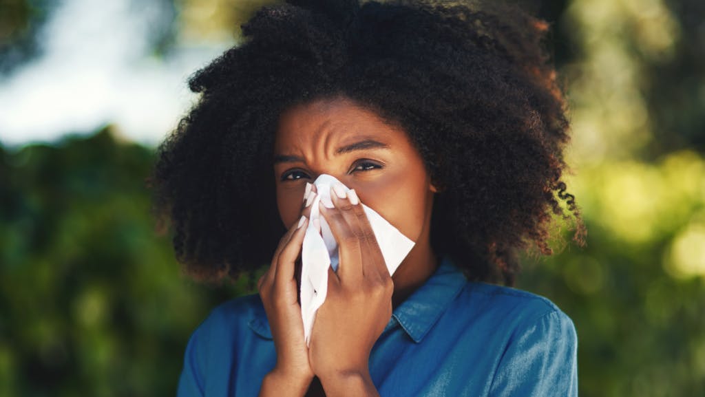 woman blowing her nose