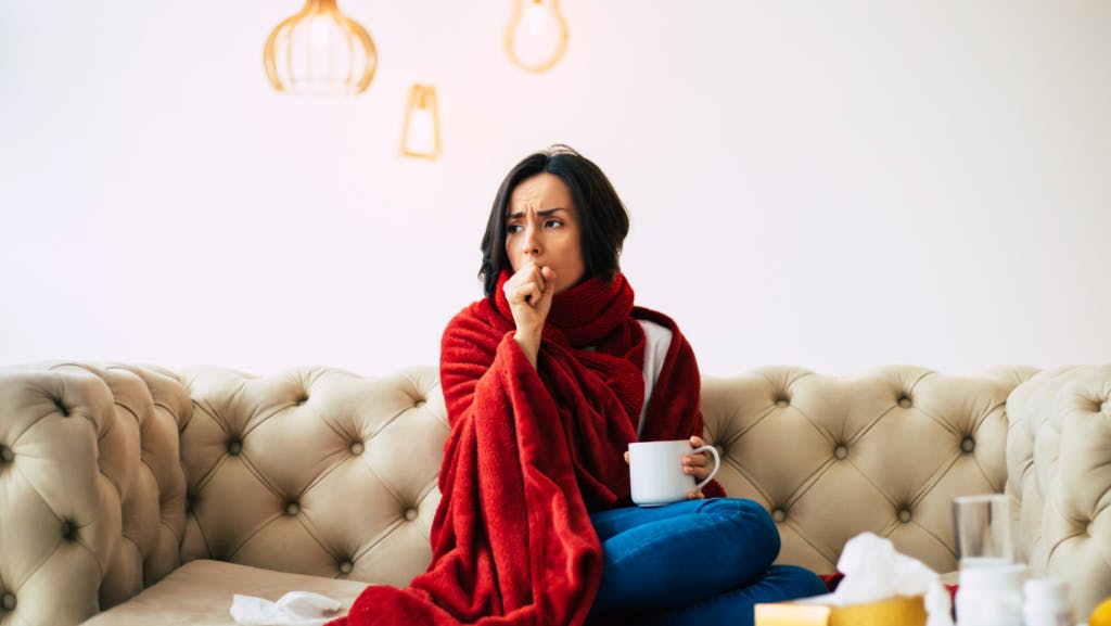 woman sick on couch