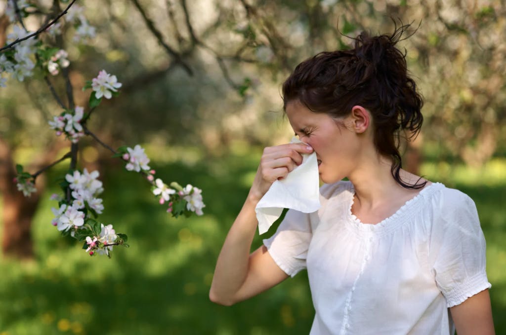Woman blowing nose