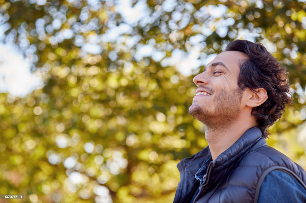 Smiling men with trees in background