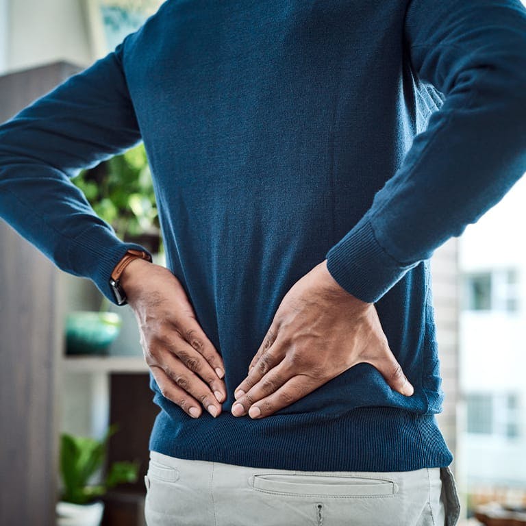 man holding his lower back