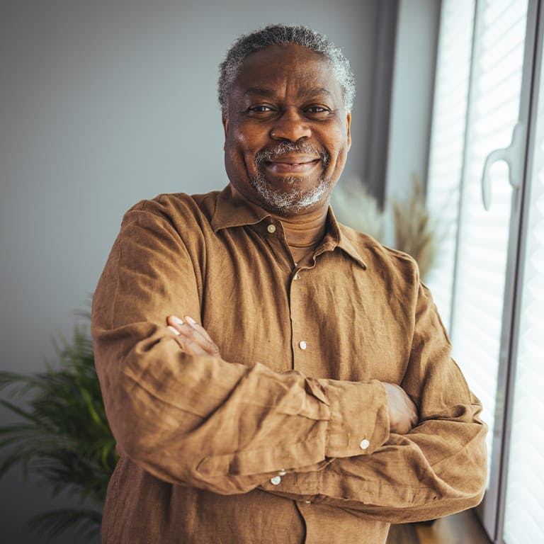 older man crossing his arms