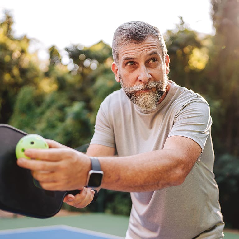 older man playing wiffle ball