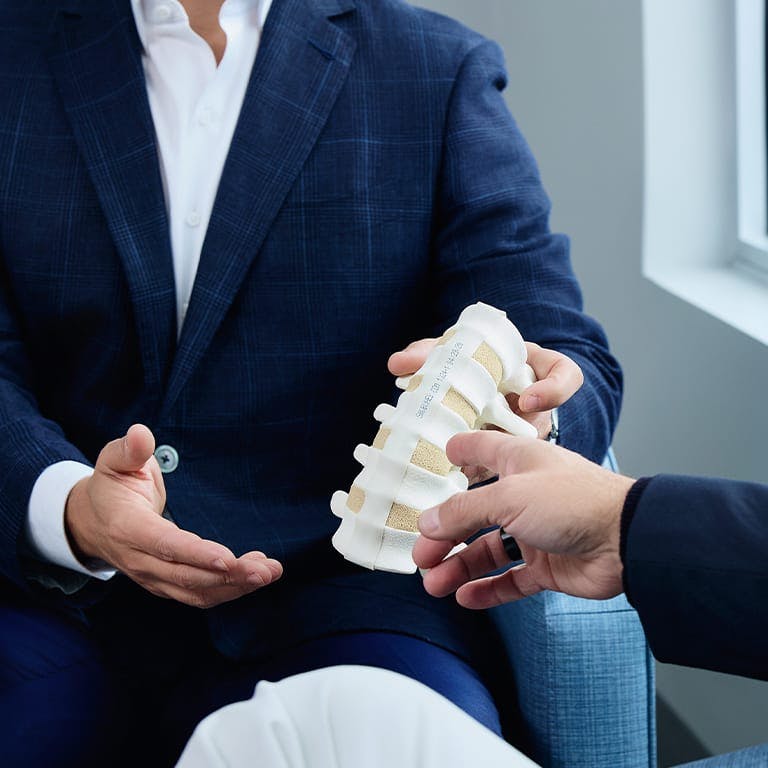 person pointing to a plastic spine