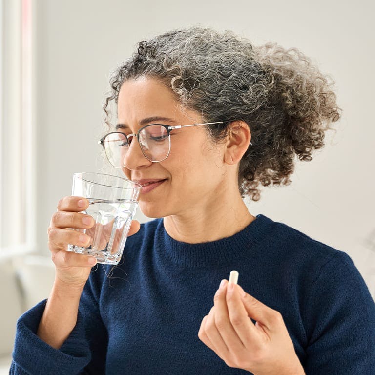 woman taking a pill