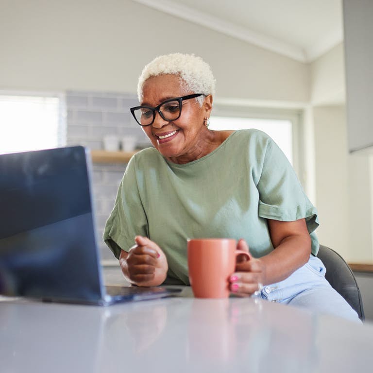 older woman looking at a laptop
