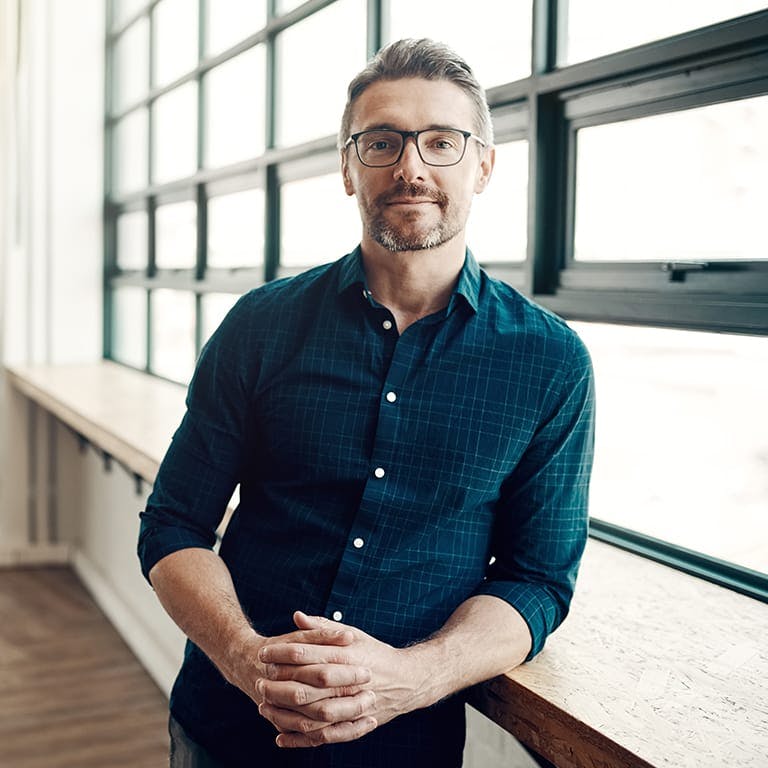 man leaning against a bar