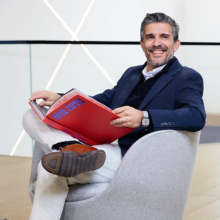 man reading a book in a waiting area