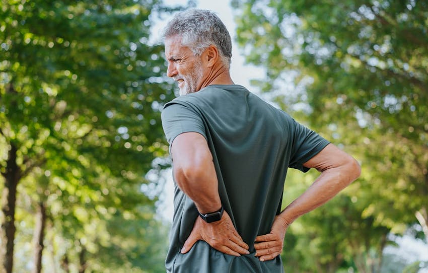 man holding his lower back