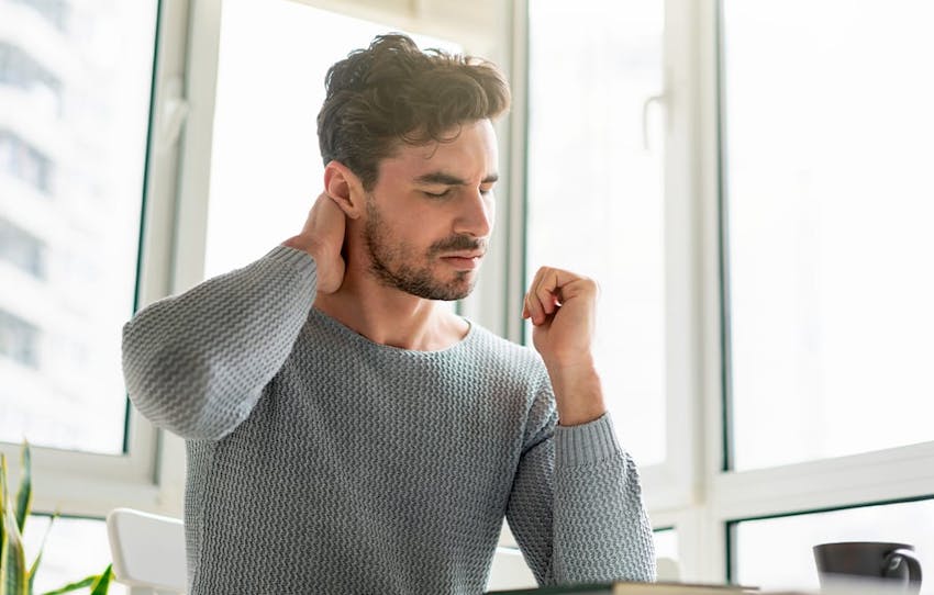 man holding the back of his neck
