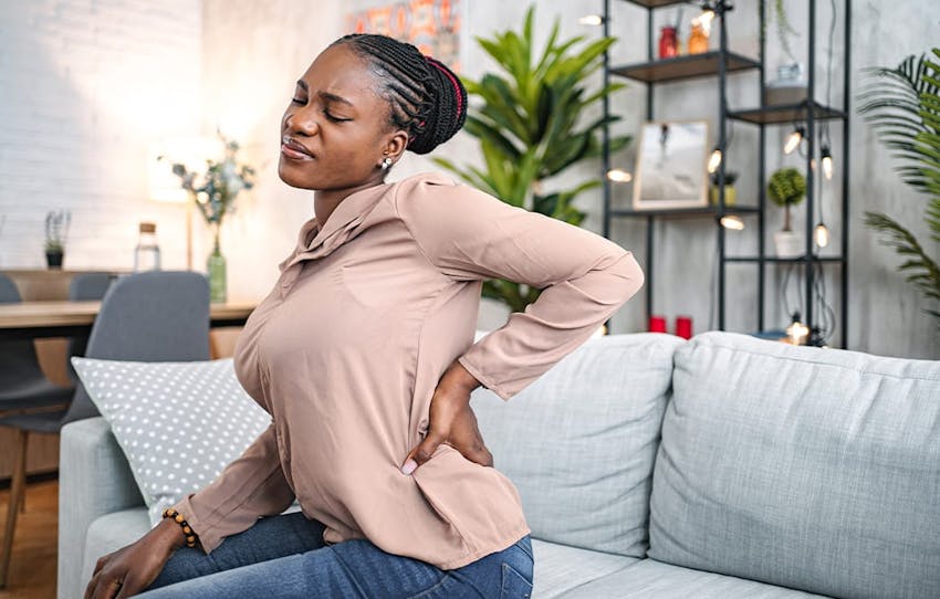 woman holding her lower back