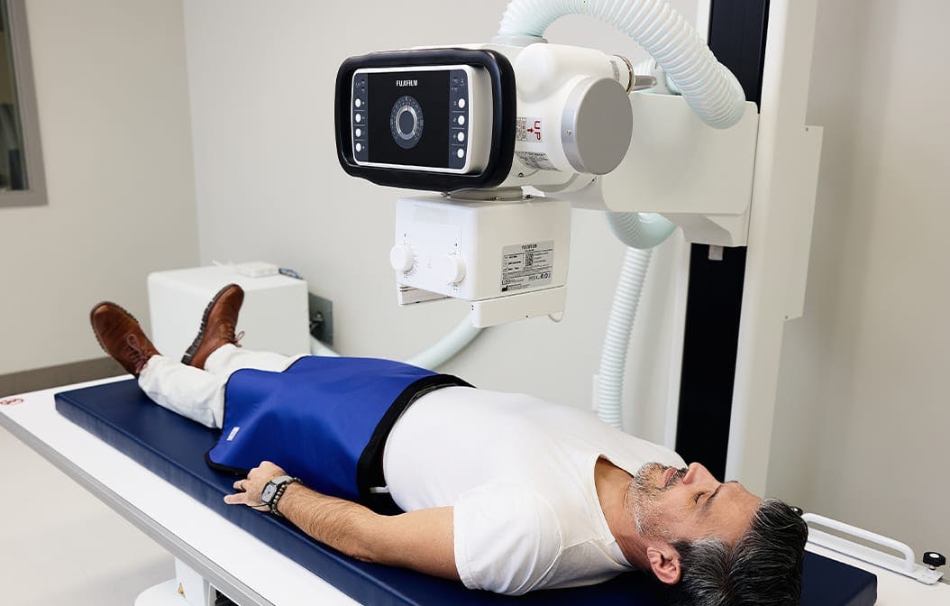 person laying in a medical machine