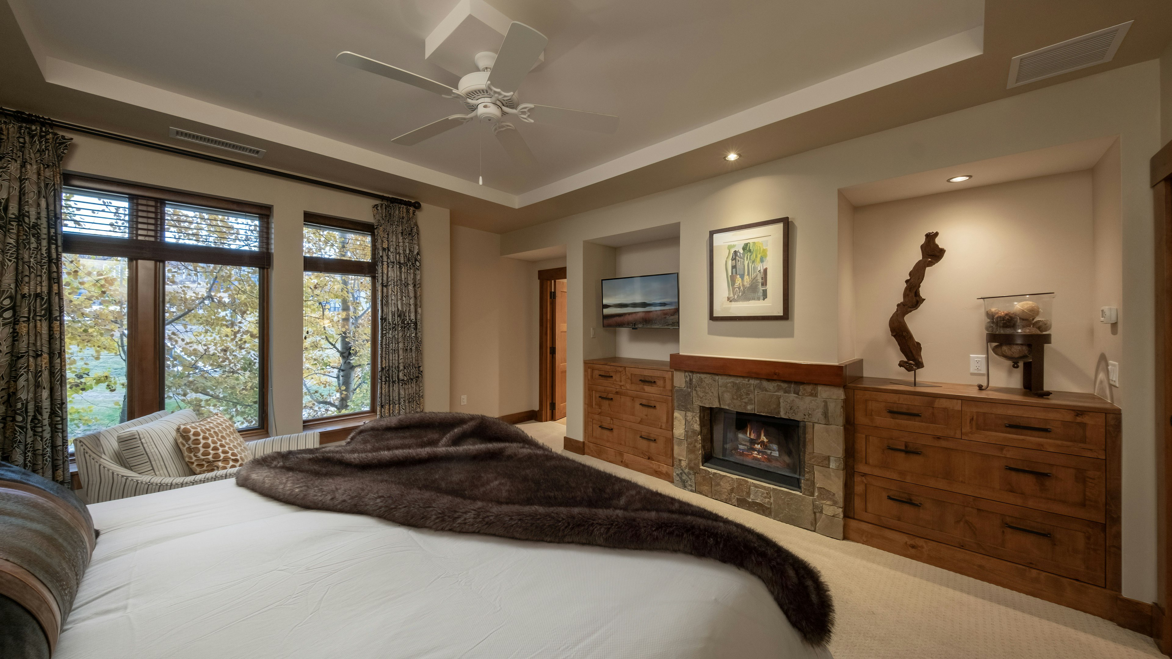 Primary suite with fireplace and TV