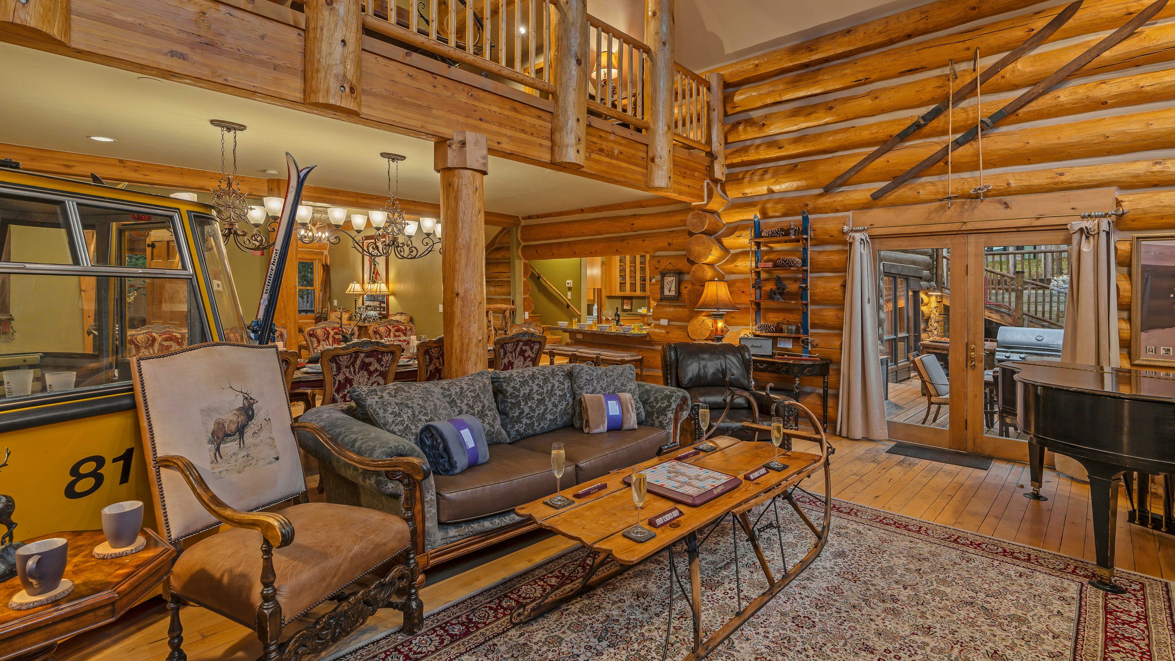 Open great room with gondola car, piano, and deck access