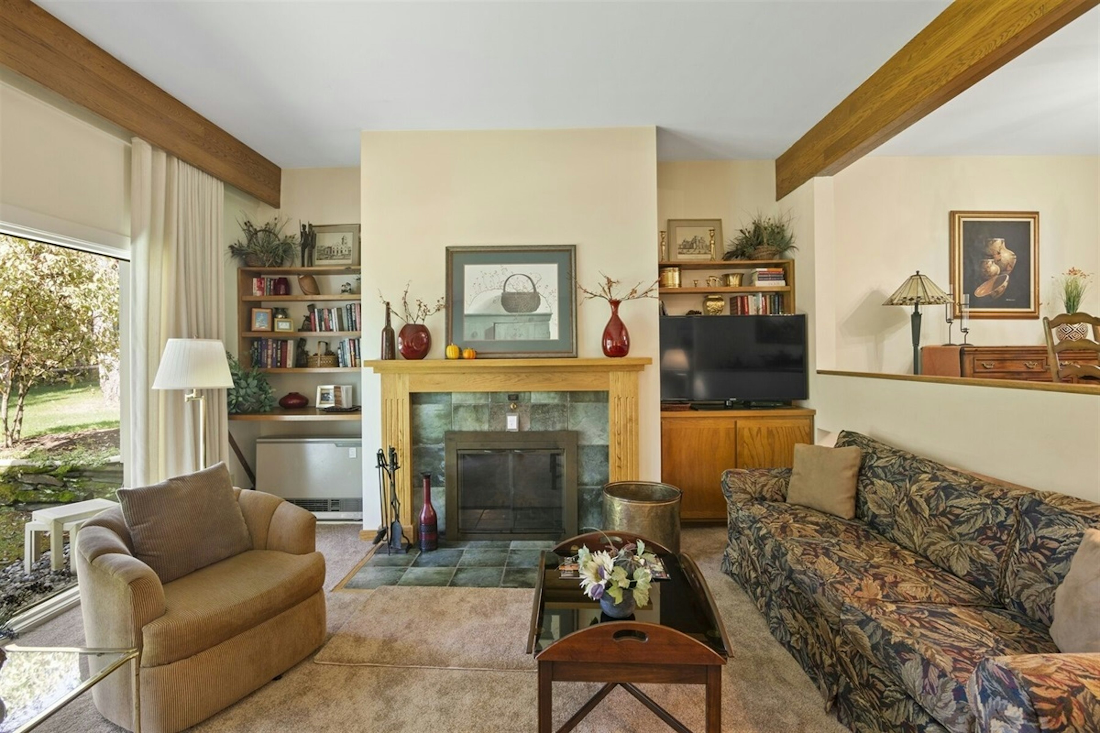 Spacious and comfortable living room with fireplace and flat screen TV